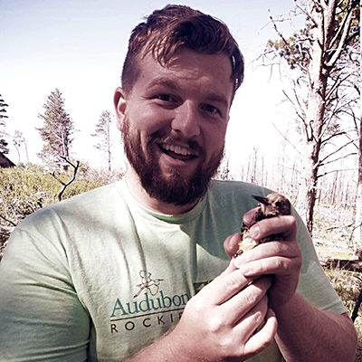 An image of Zach Hutchinson holding a sapsucker