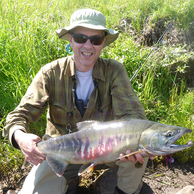 A photograph of Scott Schell with a large trout